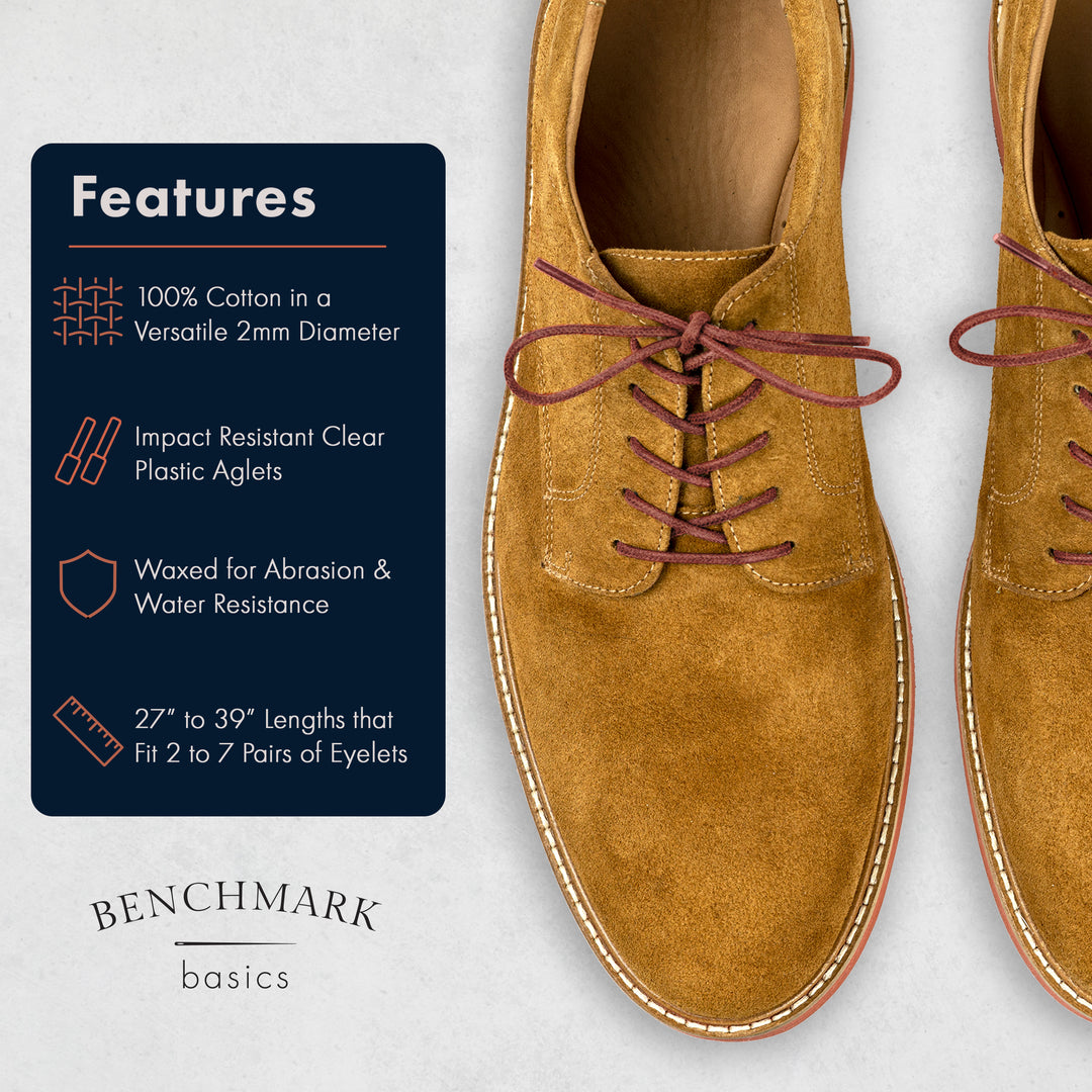 Brown suede shoes with laces on a light gray background, featuring Benchmark Basics branding. #color_brick-red