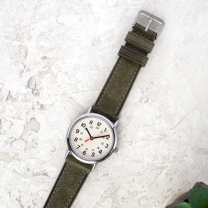 Watch with a grey strap on a light gray surface #color_grey