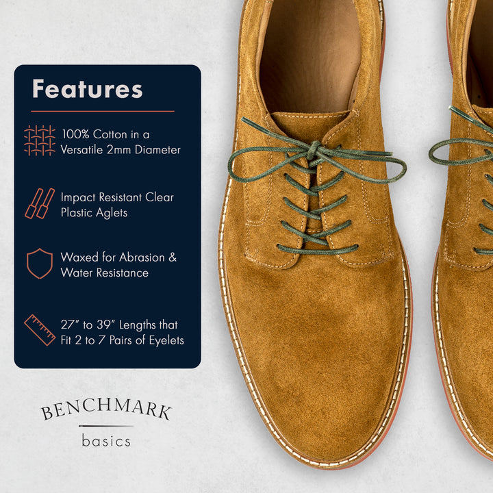 Brown suede shoes with green laces on a light gray background, featuring Benchmark Basics branding. #color_army-green
