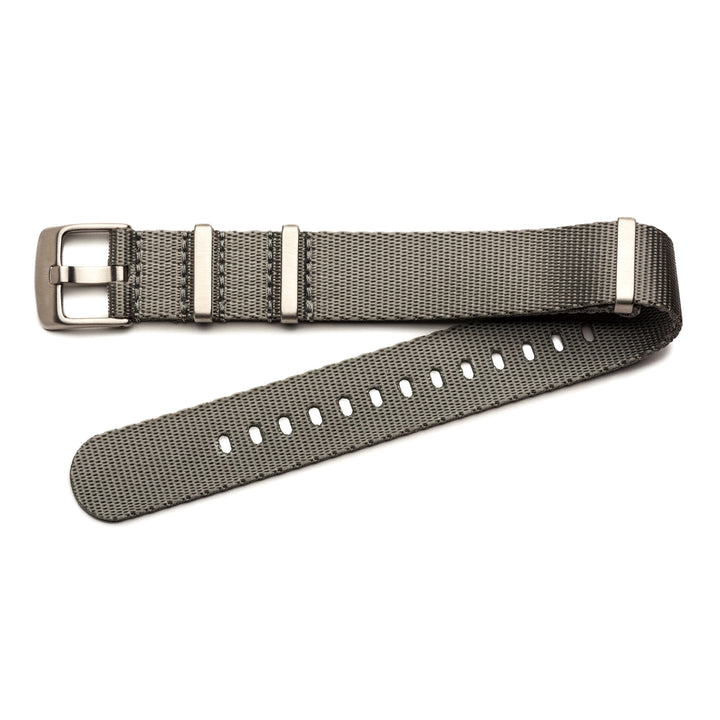 Gray woven watch strap with silver buckle on a white background #color_grey