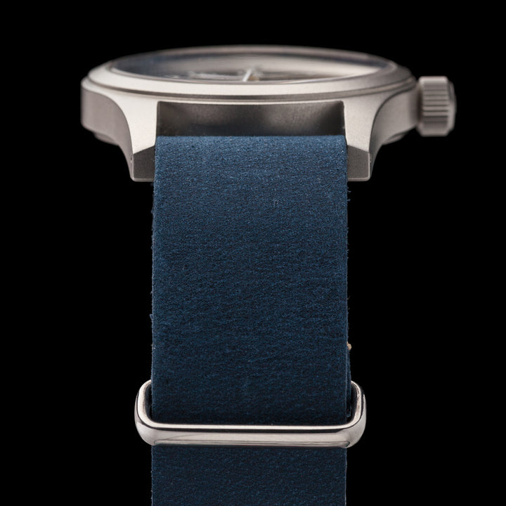 Watch with a blue strap and silver case on a black background #color_navy-blue