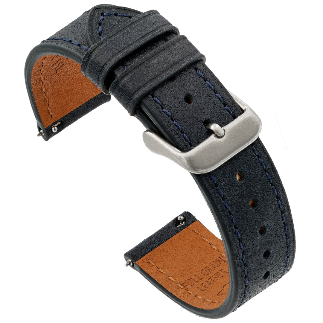 blue leather watch strap with brown interior and silver buckle on a white background #color_navy-blue
