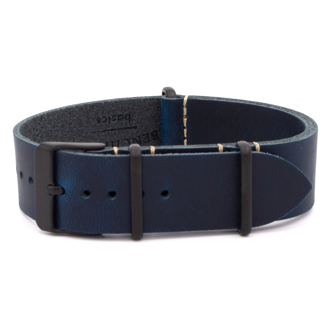Navy blue leather watch strap with black hardware on a white background #color_navy-blue-pvd