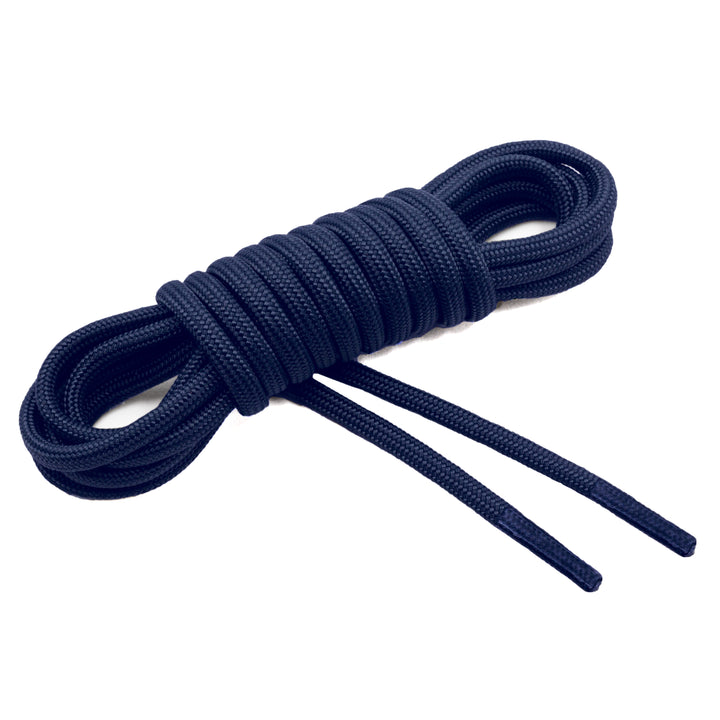 A coiled navy blue paracord lace with clear plastic aglets and a woven nylon sheath. #color_navy-blue