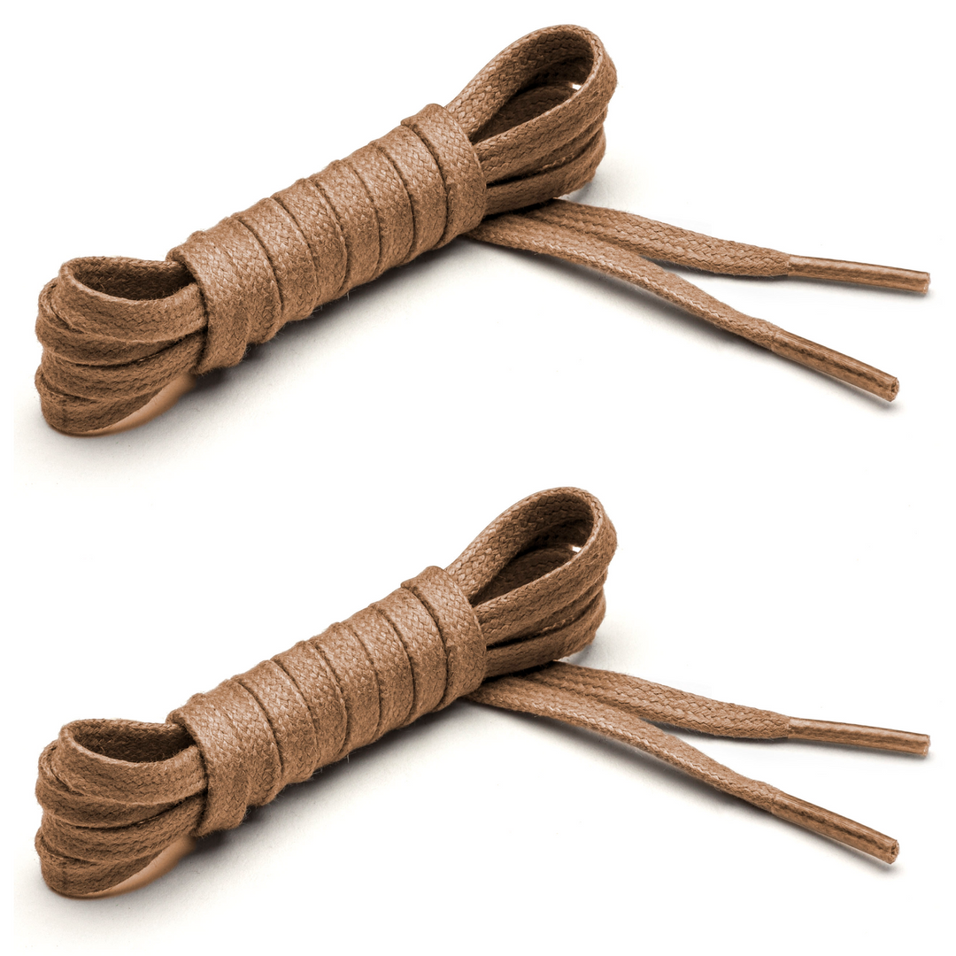 Two pairs of flat waxed cotton tan shoelaces with clear aglets, coiled and placed side by side. #color_tan