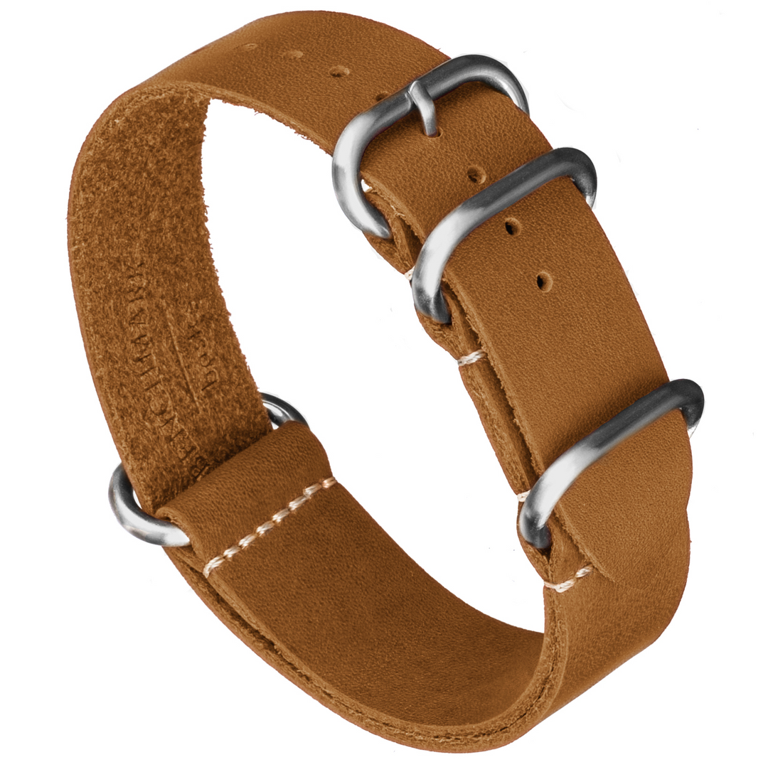 A brown oil-tanned leather watch strap with a Zulu style one piece design, featuring silver buckle and ring hardware. #color_sand